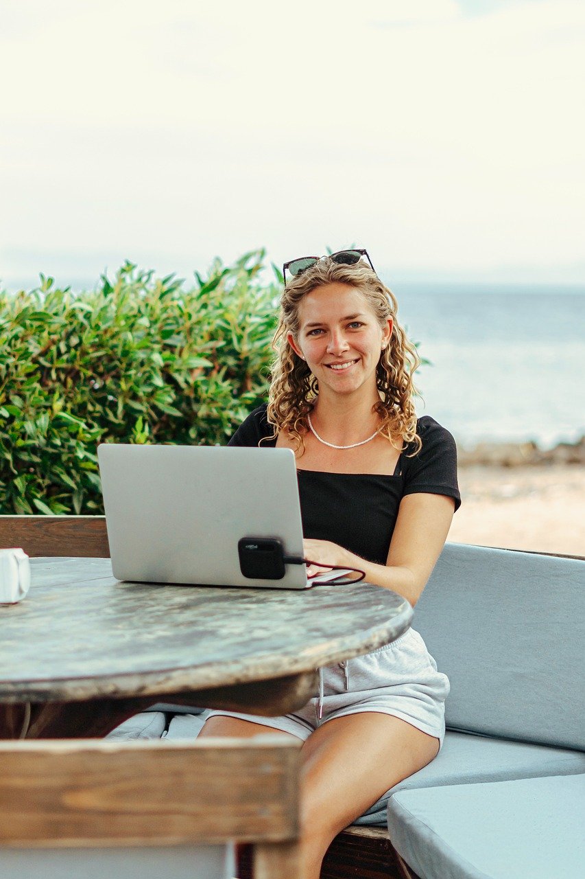 Woman happily looking at her laptop feeling the results of Online DBT Therapy
