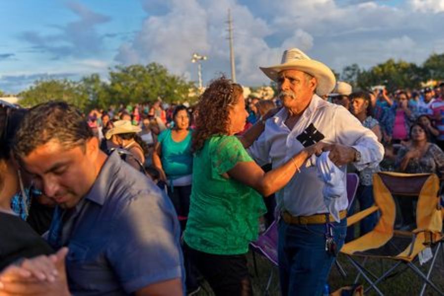 Latino community members enjoying an event in Texas celebrating culture and mental health